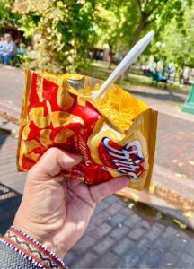 Frito Pie in a Frito's bag held in a hand.