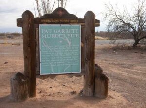 A sign marking the spot where Pat Garrett was murdered, part of Las Cruces history.