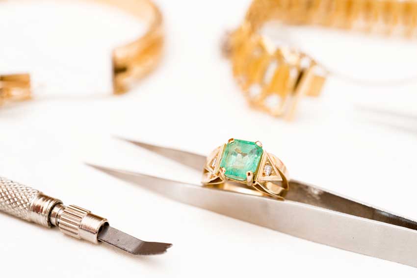 Jewelry pice in tweezers for jewelry repair.