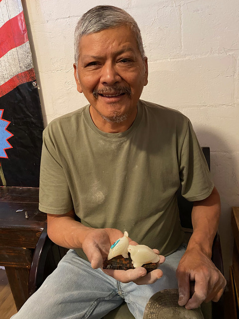 Zuni carver Jimmy Yawakia welcomes visitors to his home workshop where he’ll teach you how to make fetish figures. Photo by Paul Ross from the book "Slow Travel New Mexico."