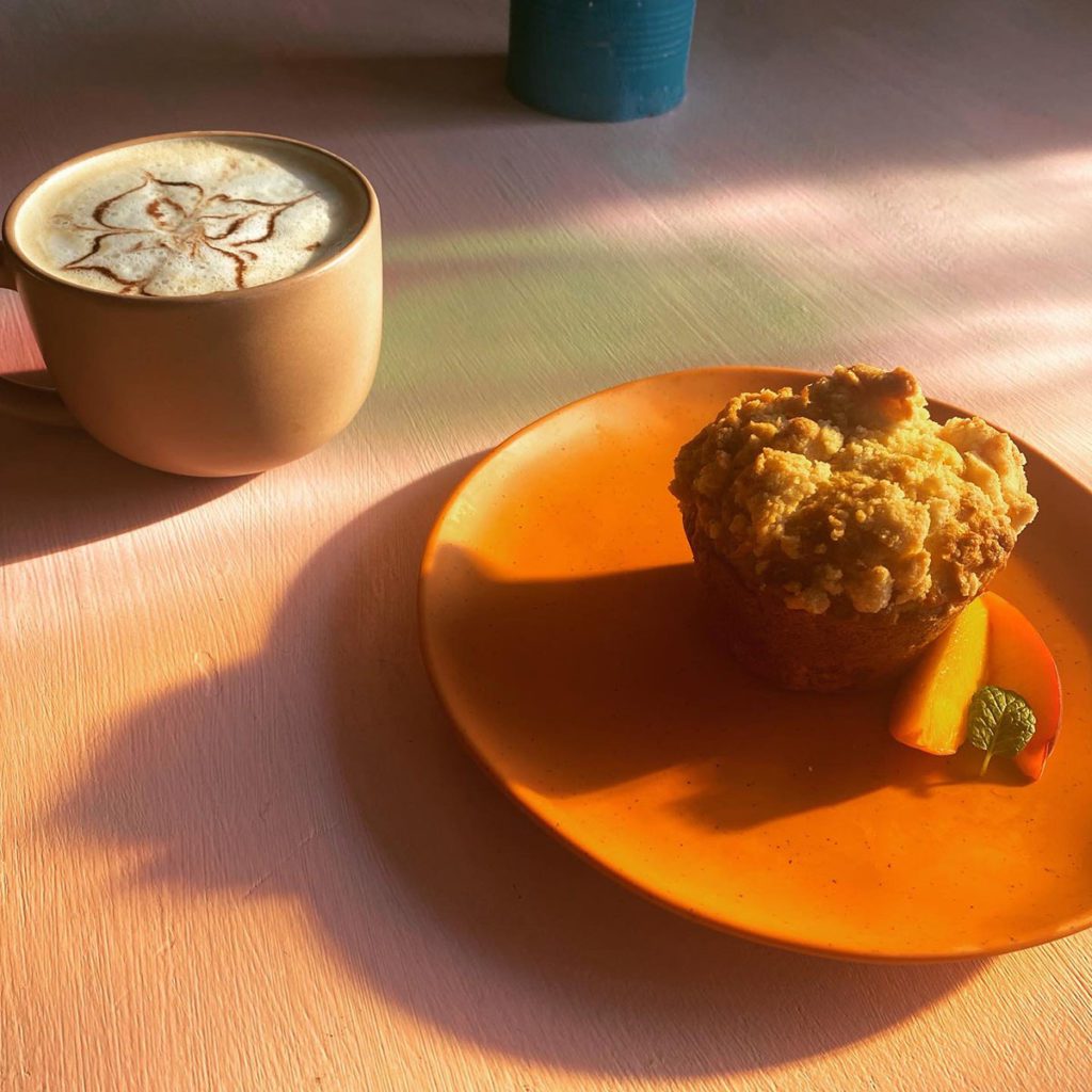 A coffee drink and a muffin.