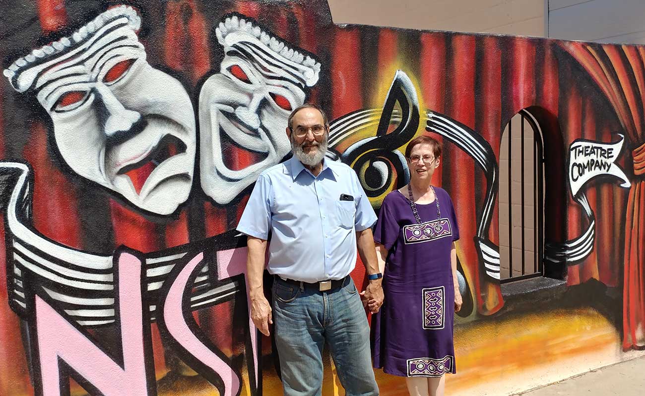 Peter and Ceil Herman in front of a curtain at the Black Box Theatre