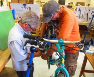 Men working on bicycle at The Hub