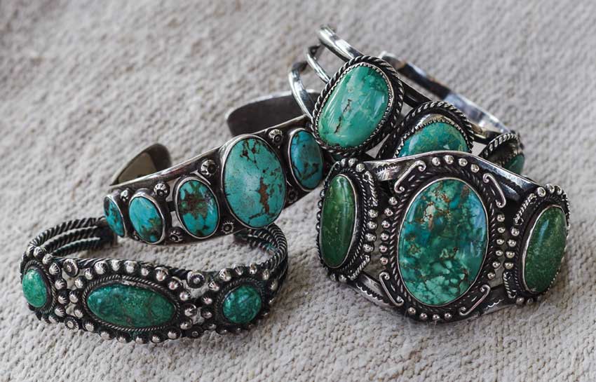 Navajo bracelets of turquoise and silver feature classic Native American jewelry styles.