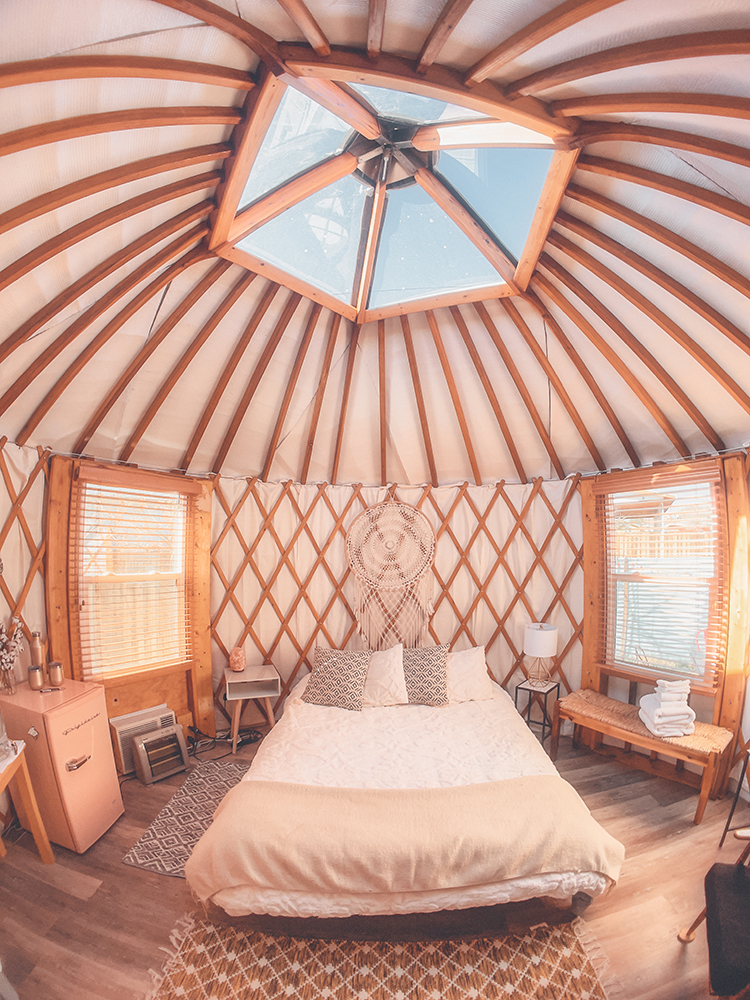 inside of a luxury yurt in T or C that has a big bed.
