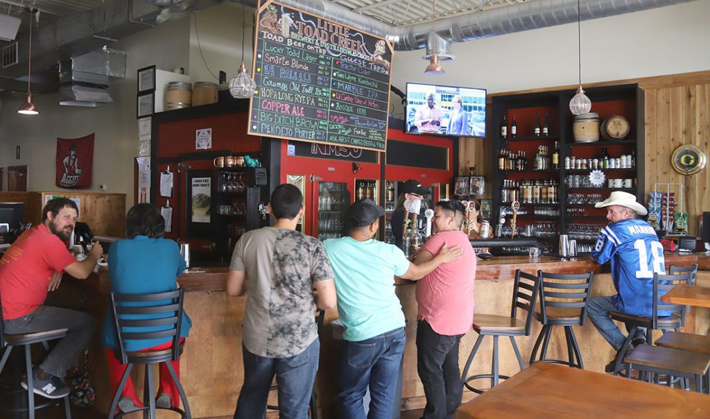 People enjoying beers and cocktails at downtown bar and brewery Little Toad Creek.